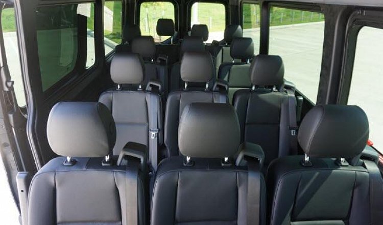 Rows of seats inside a 12-passenger van, an alternative to a 12 seater minivan rental